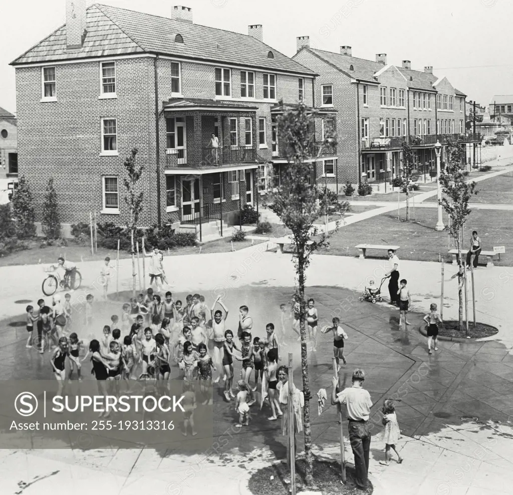 Vintage photograph. Children playing outside in fountain at Iberville Public Housing in New Orleans, Louisiana