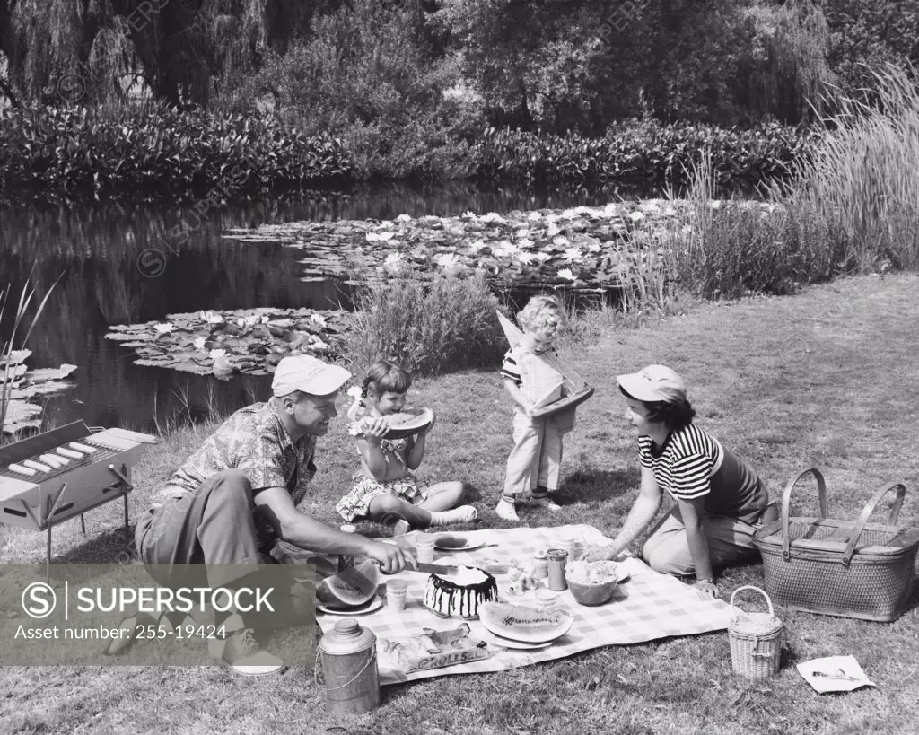 Family having a picnic near a pond