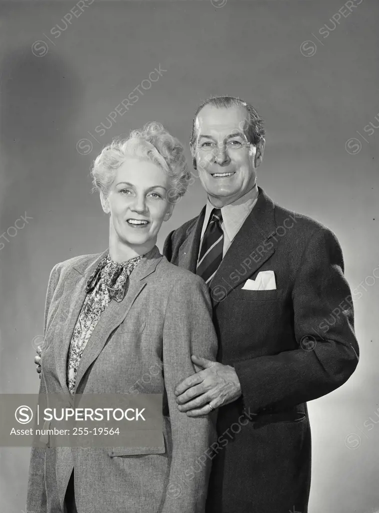 Vintage Photograph. Man holding woman from behind while smiling