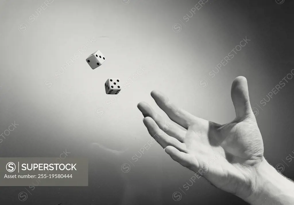Vintage photograph. Hand rolling dice