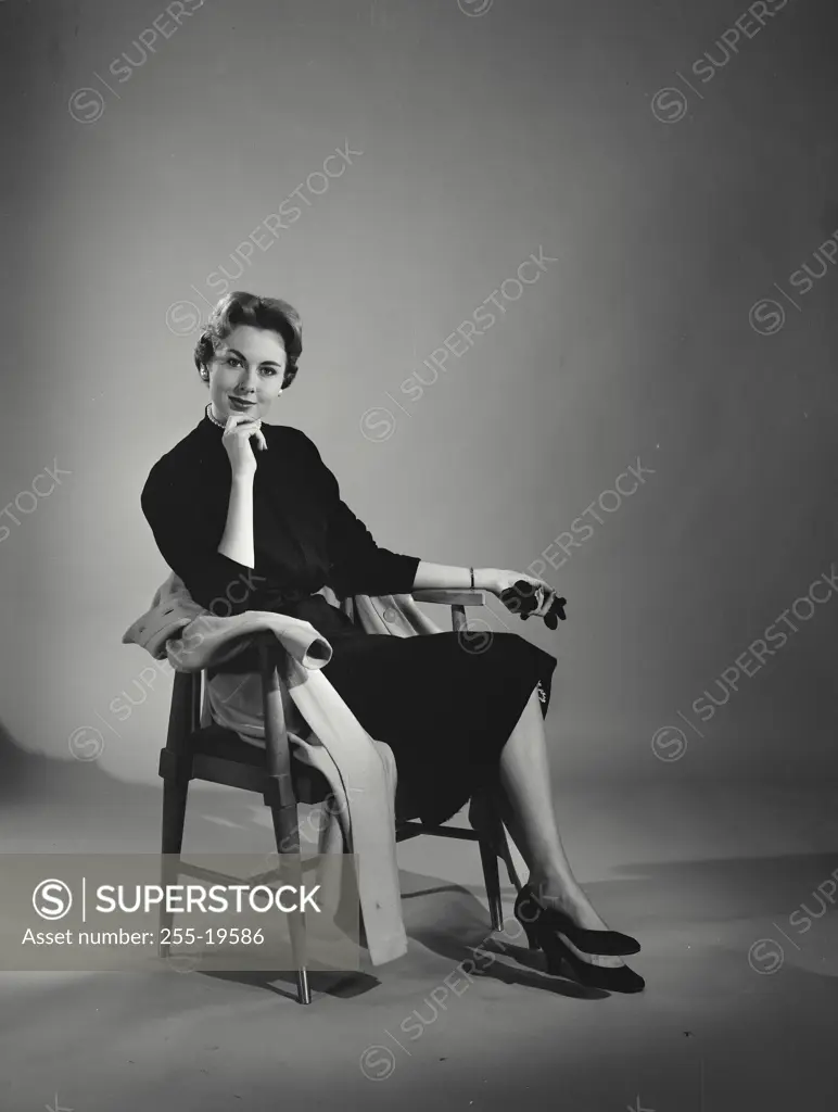 Vintage Photograph. Woman in black dress sitting in wooden chair. Frame 4
