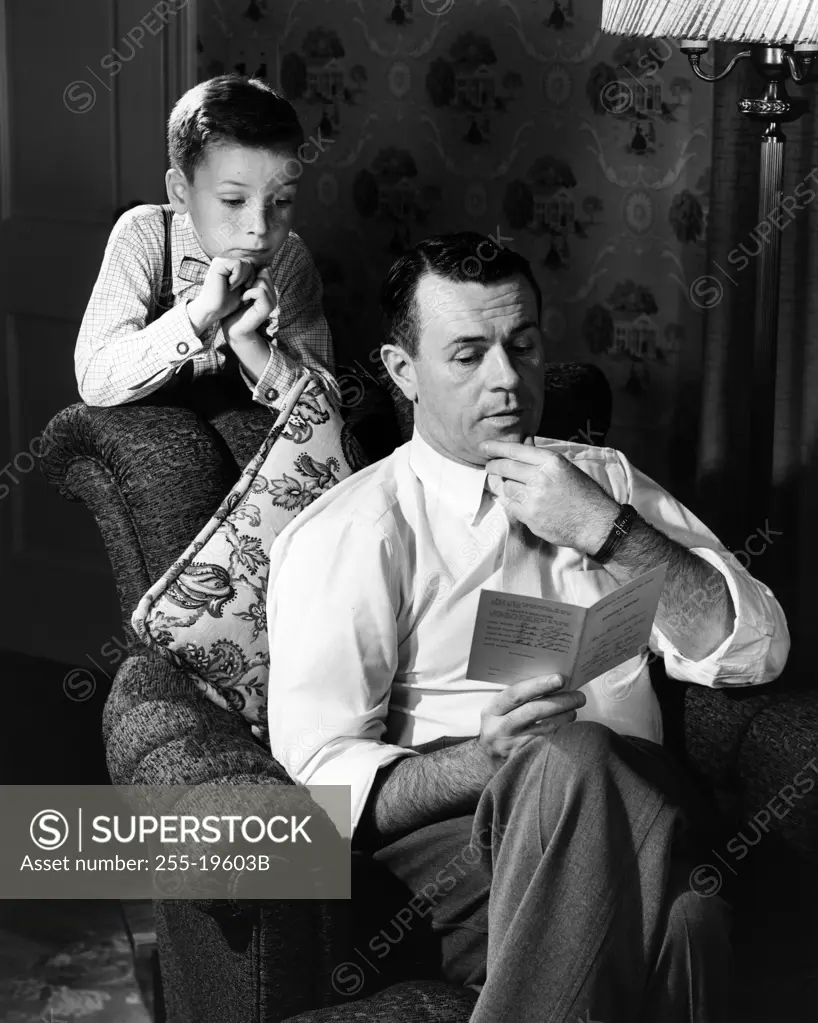 Father and son reading letter