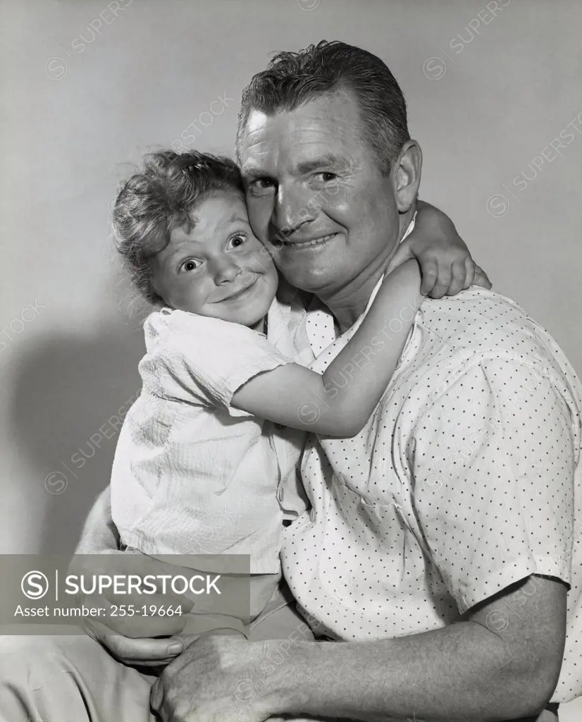 Portrait of a daughter hugging her father
