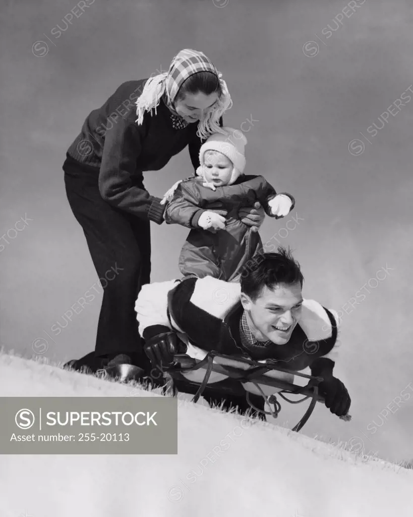 Low angle view of parents and their son on a sled