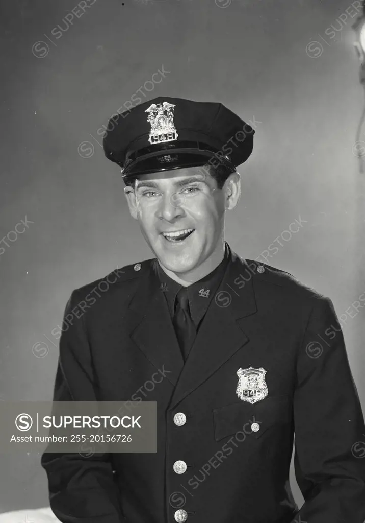 Vintage photograph. Man in police uniform smiling