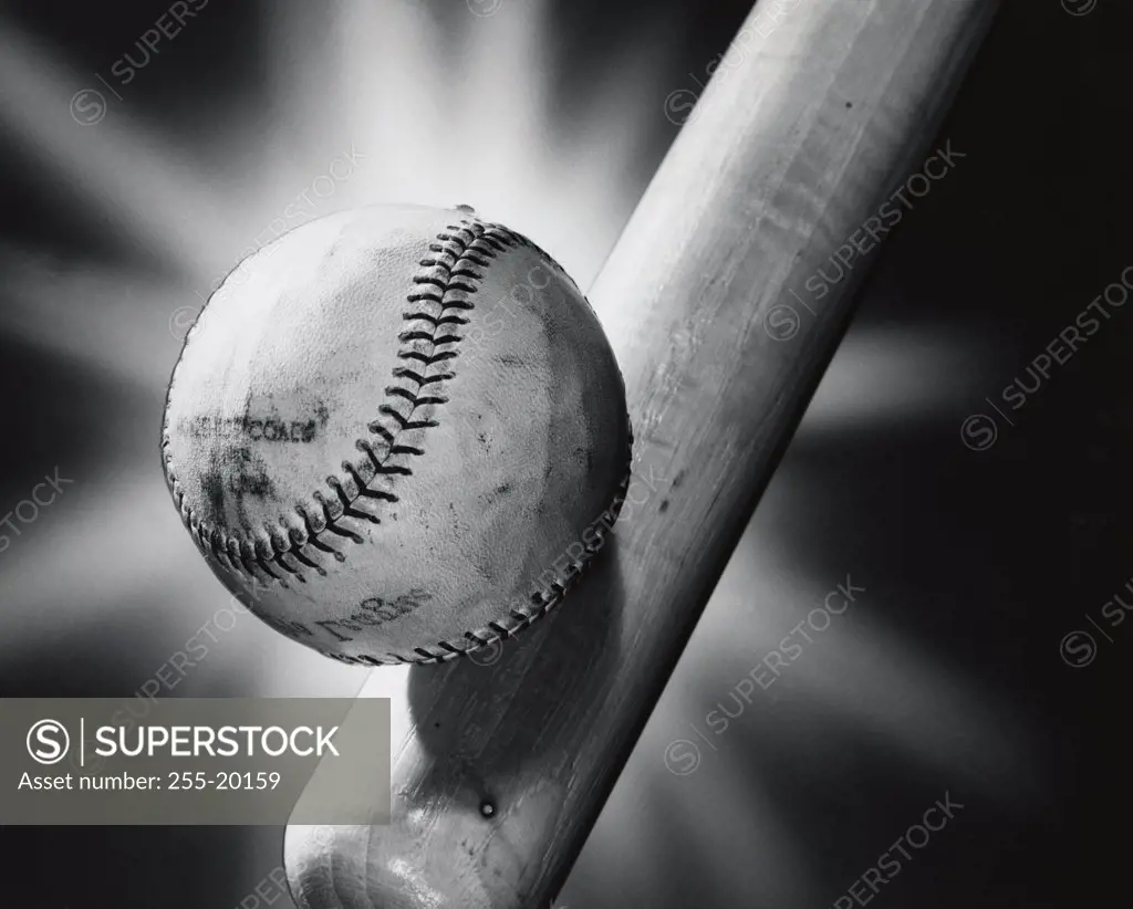 Close-up of a baseball and a baseball bat