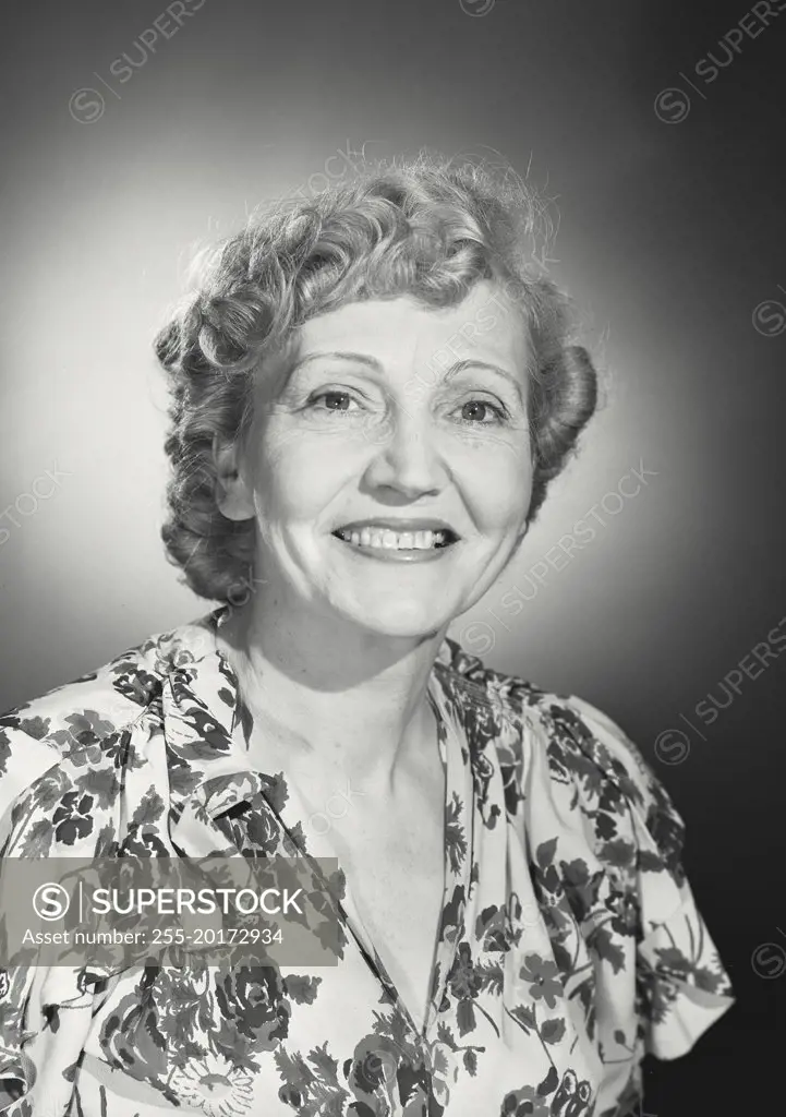 Vintage photograph. Older woman wearing floral blouse smiling