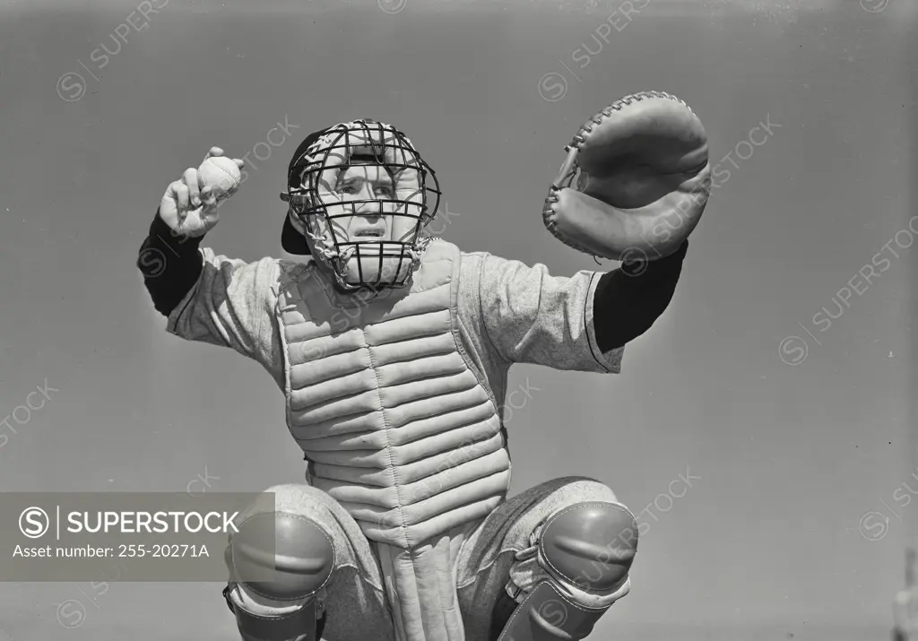 Vintage Photograph. Baseball catcher with facemask about to throw baseball Frame 1