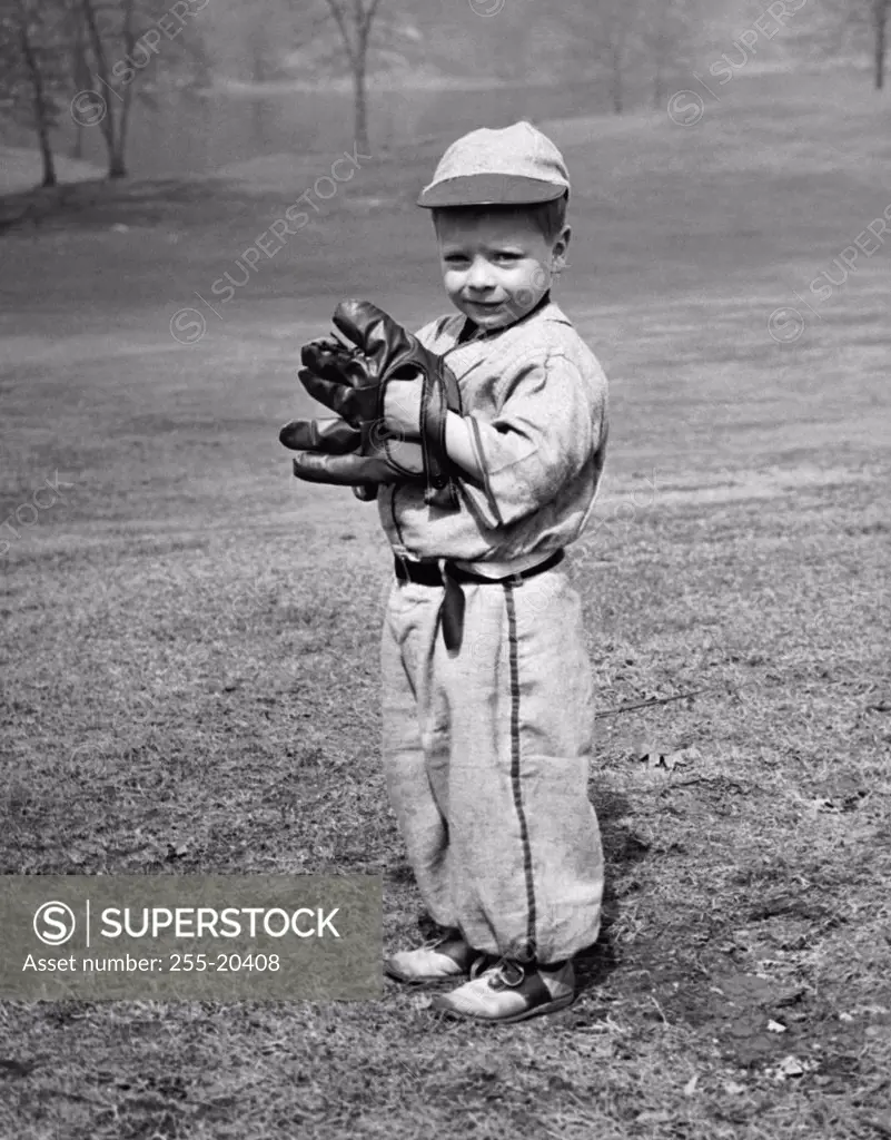 Youth league baseball player standing on a baseball field