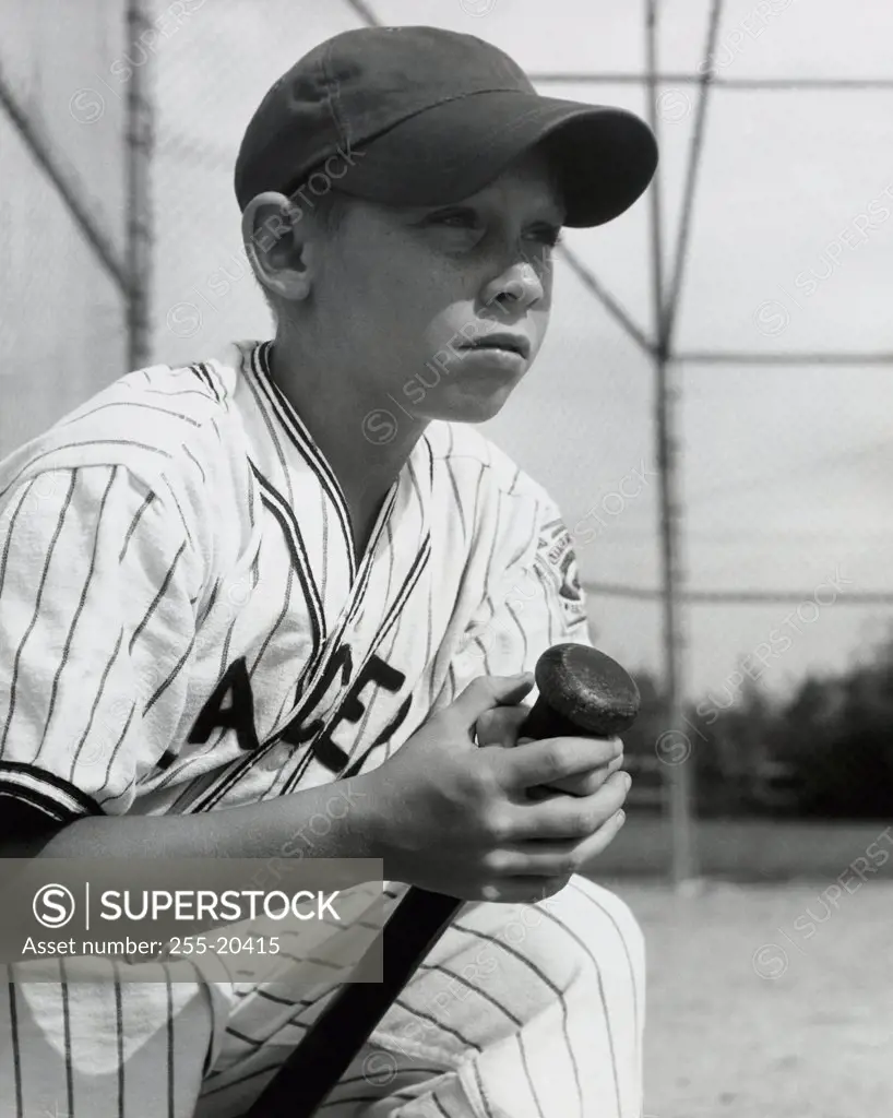Close-up of a boy holding a baseball bat