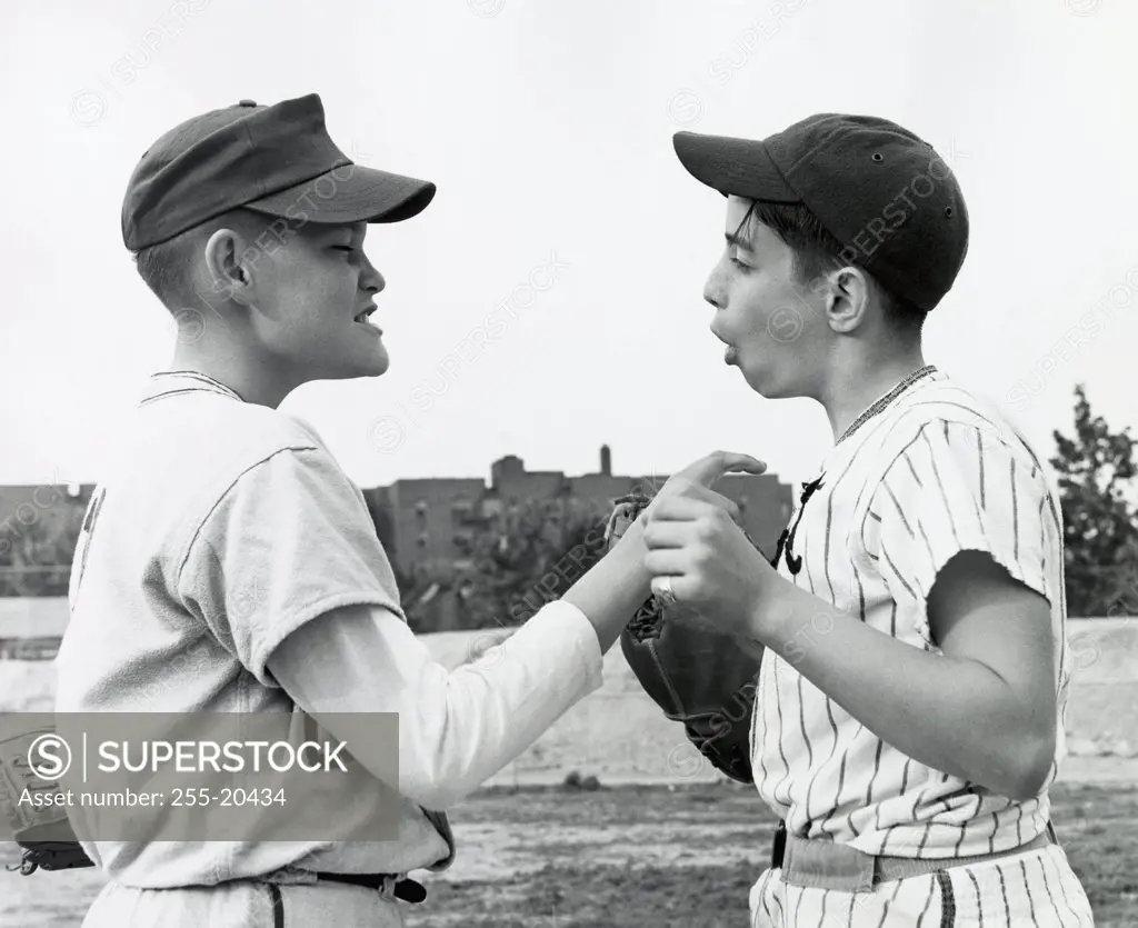 Side profile of two teenage boys arguing with each other