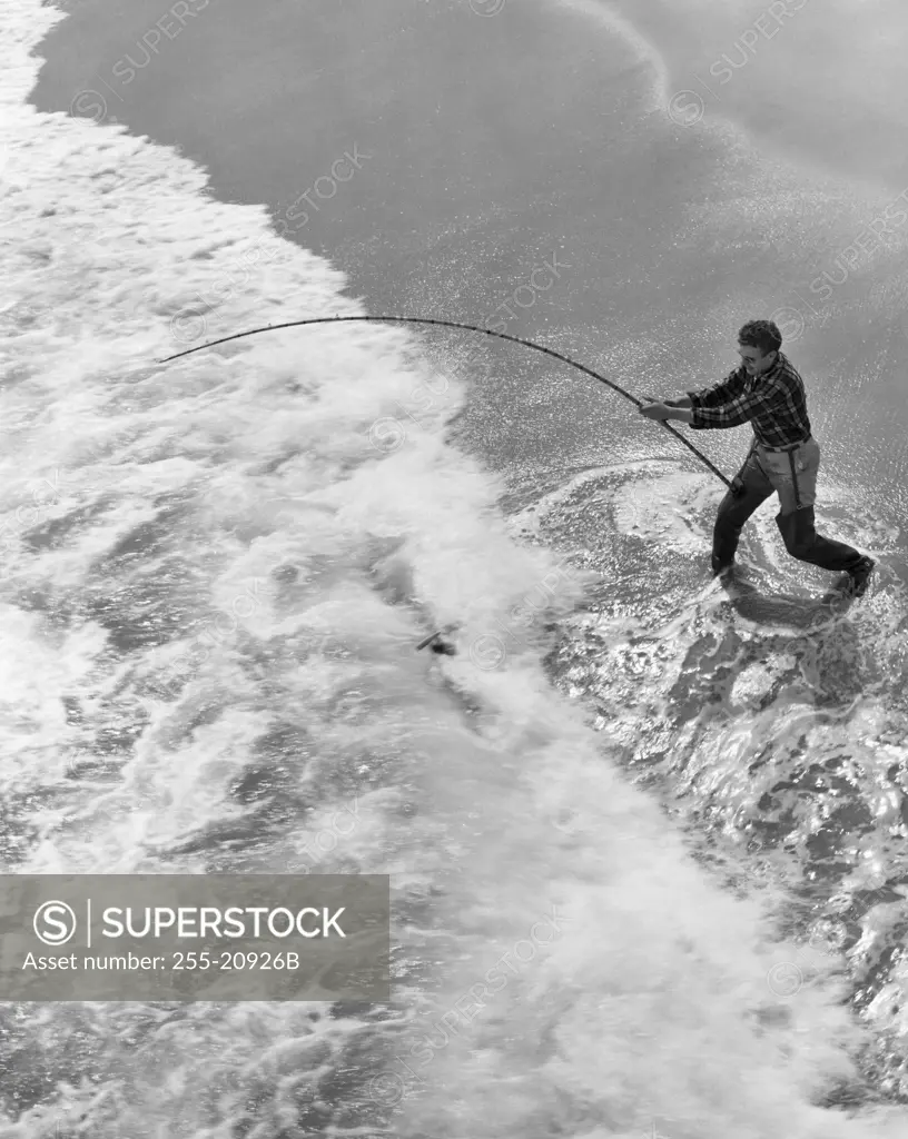 High angle view of a man fishing in the sea