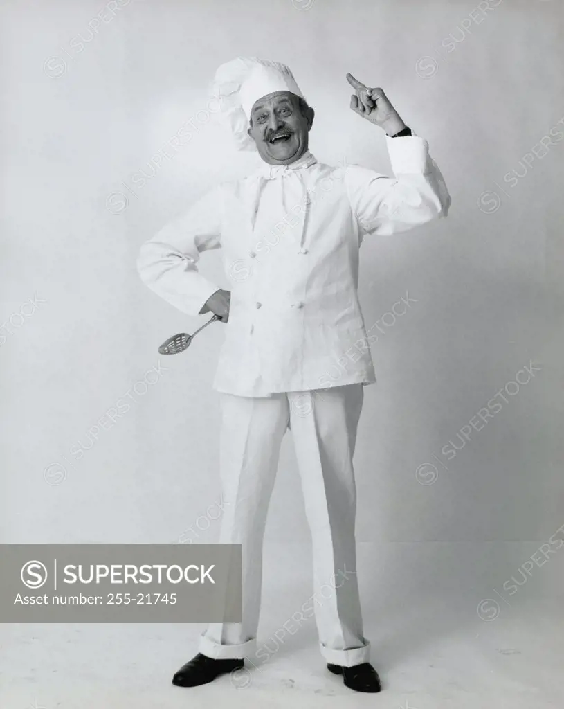 Chef smiling with his hand on his hip