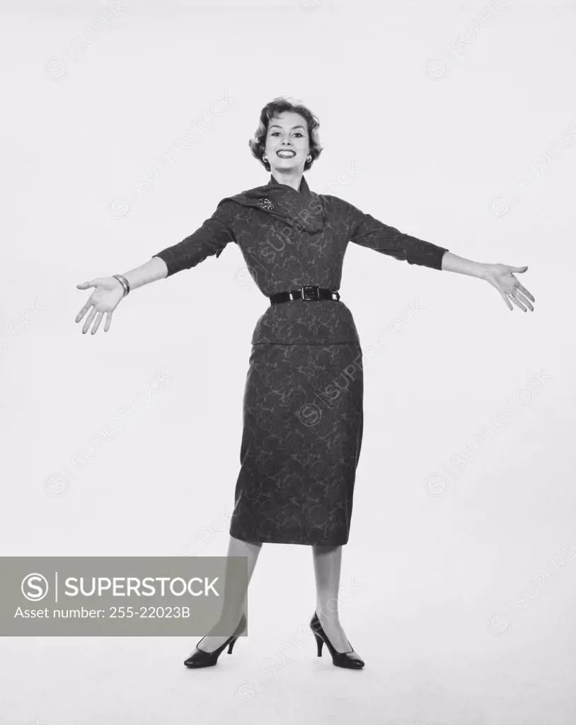 Portrait of young woman with arms outstretched