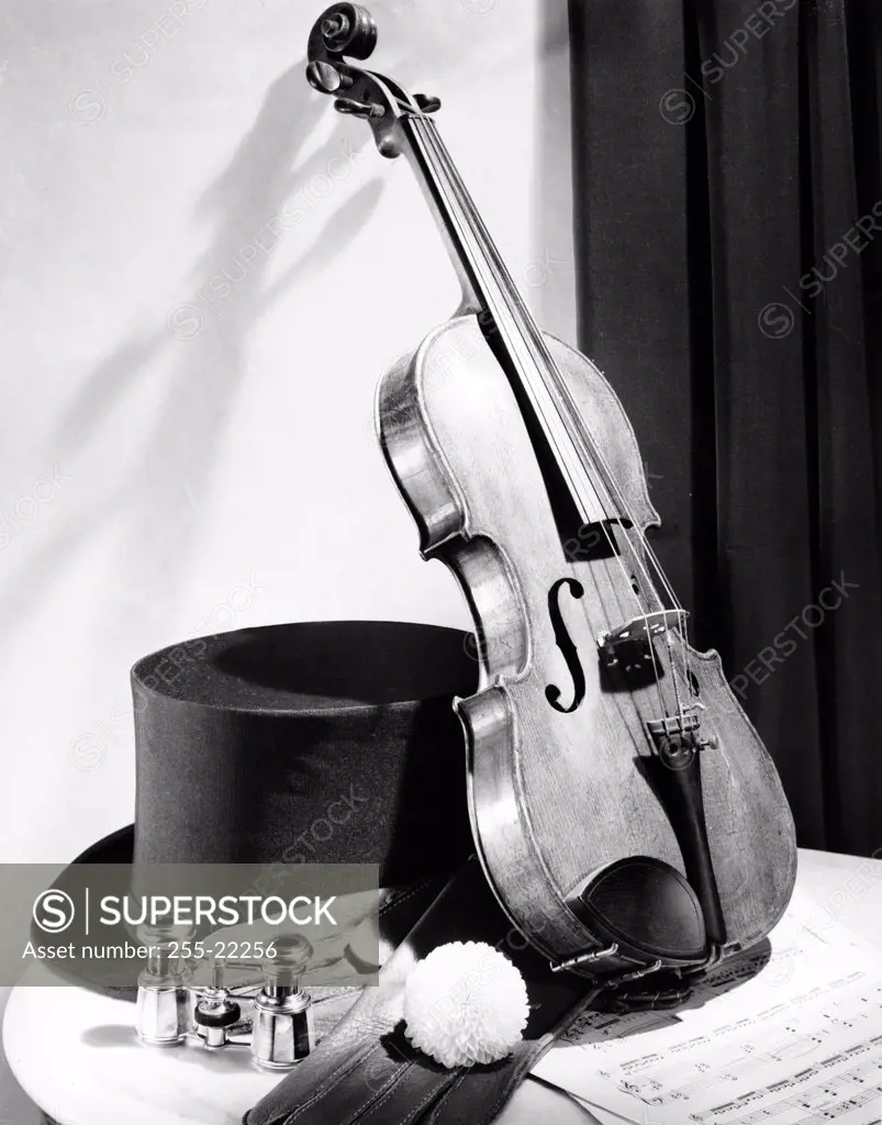 Violin with a hat on a table