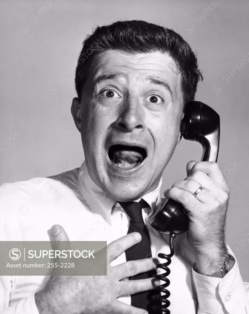 Close-up of a businessman shocked on the telephone