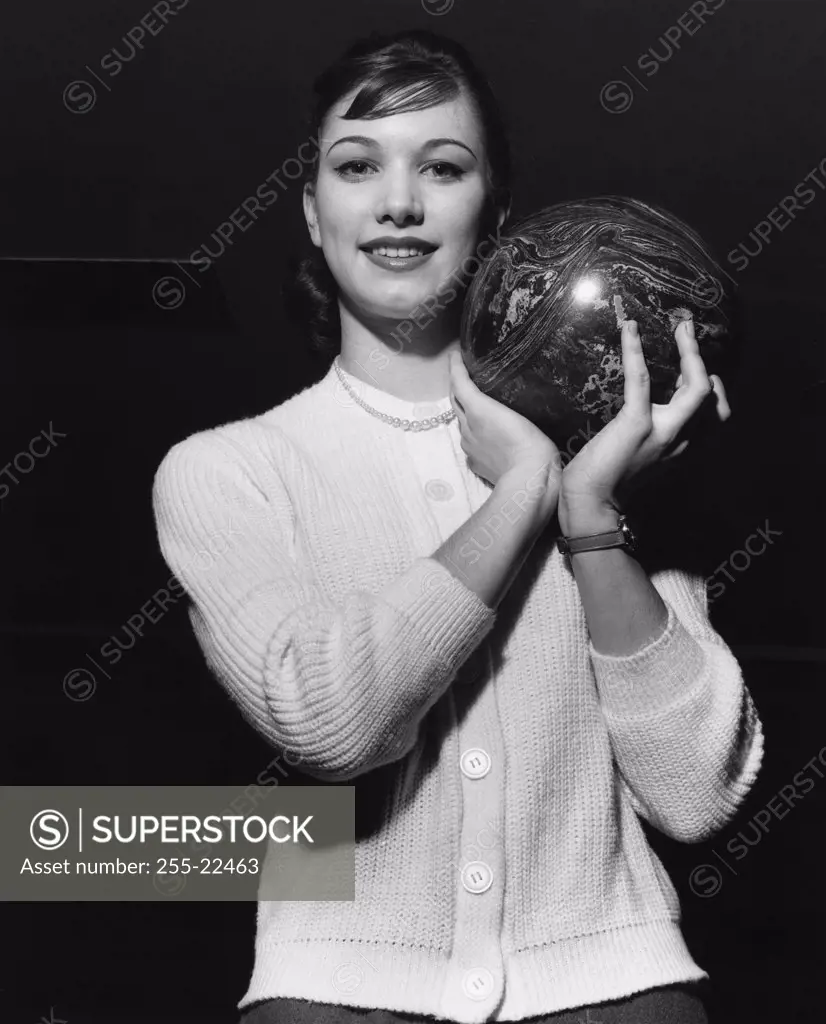 Young adult woman holding a bowling ball