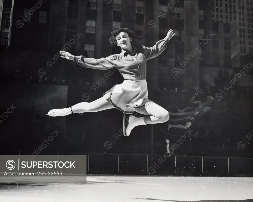 Female ice skater jumping, Rockefeller Center, Manhattan, New York City, New York, USA
