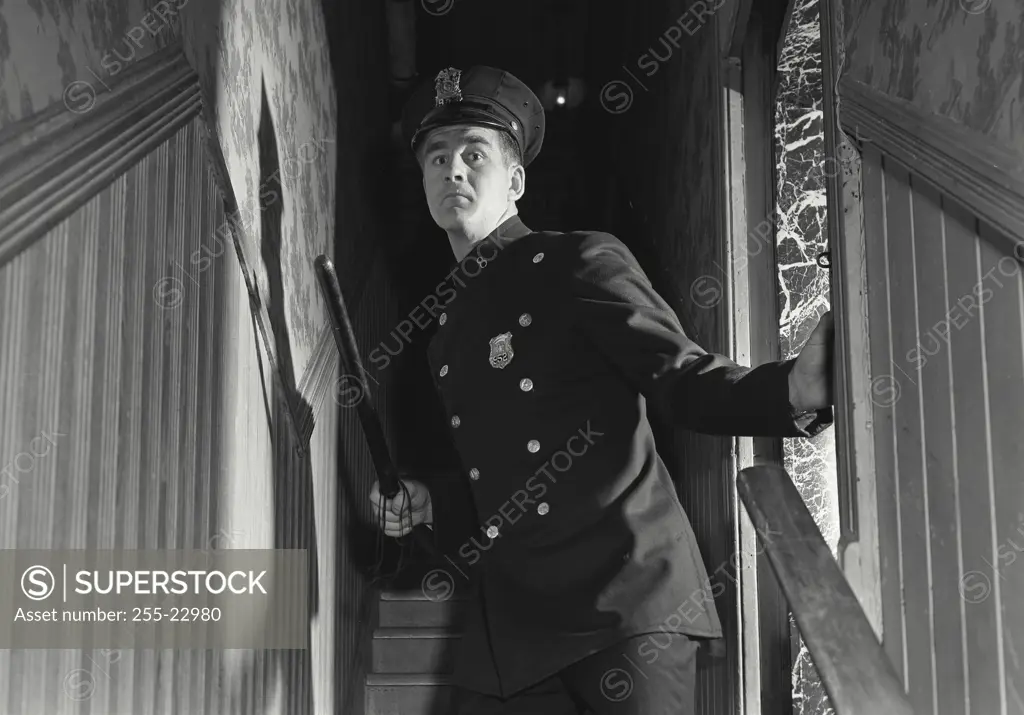 Vintage Photograph. Police officer lurking in stairway. Frame 5