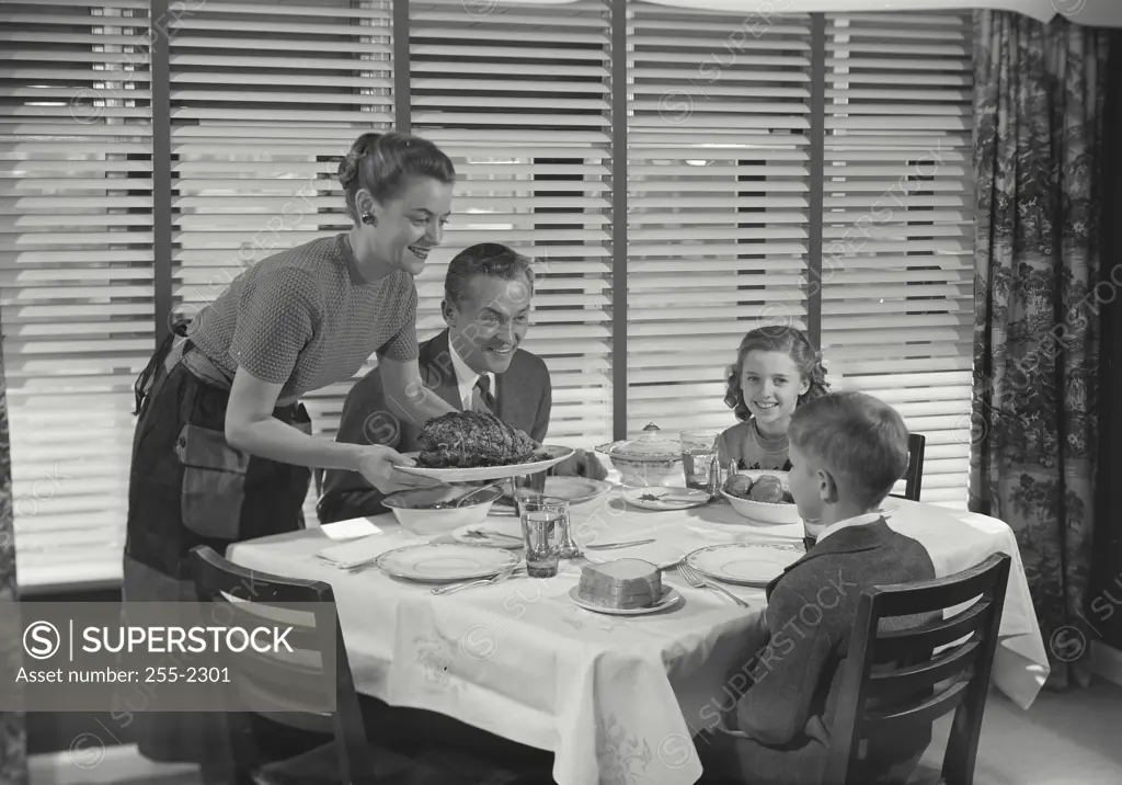 Vintage Photograph. Family at table having dinner together. Frame 2
