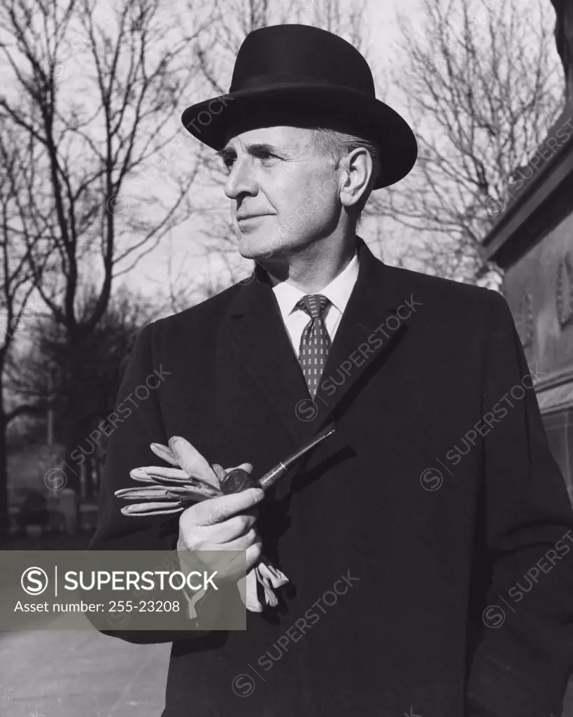 Businessman holding a pipe