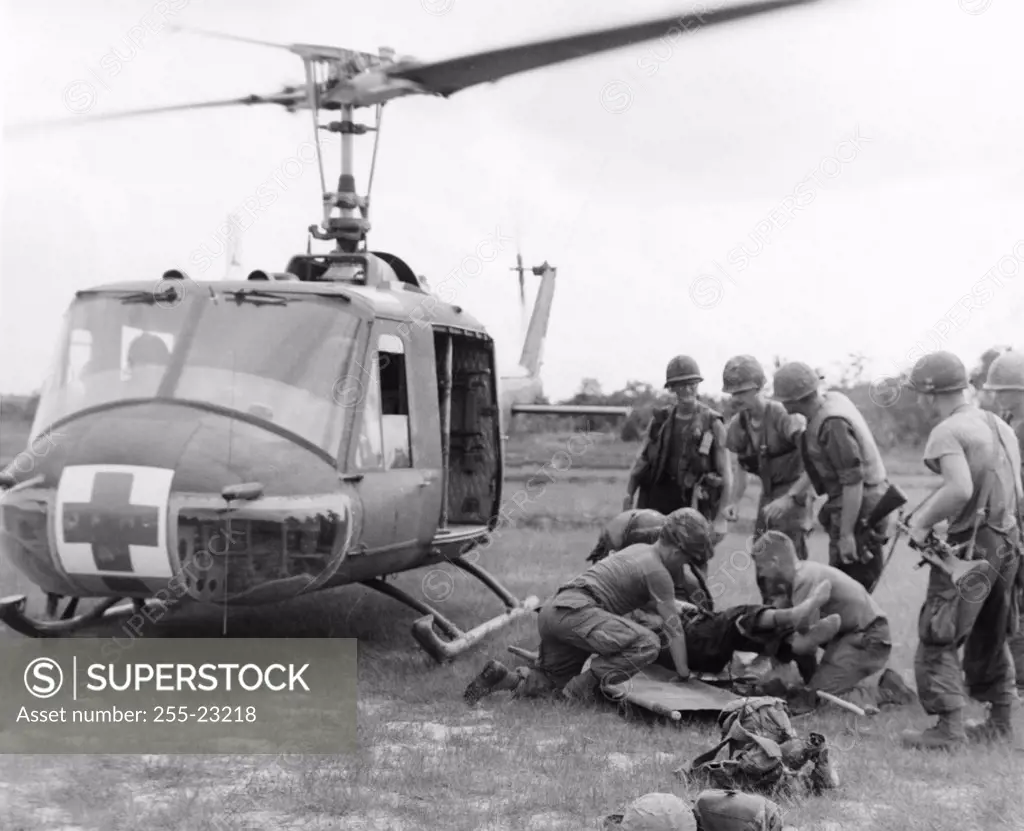 Army soldiers putting an injured person on a stretcher, US Military, May 1966