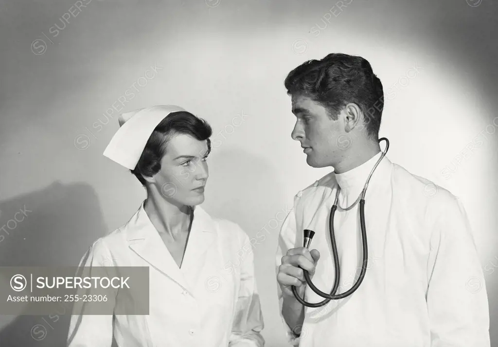 Vintage photograph. Doctor and nurse looking at each other