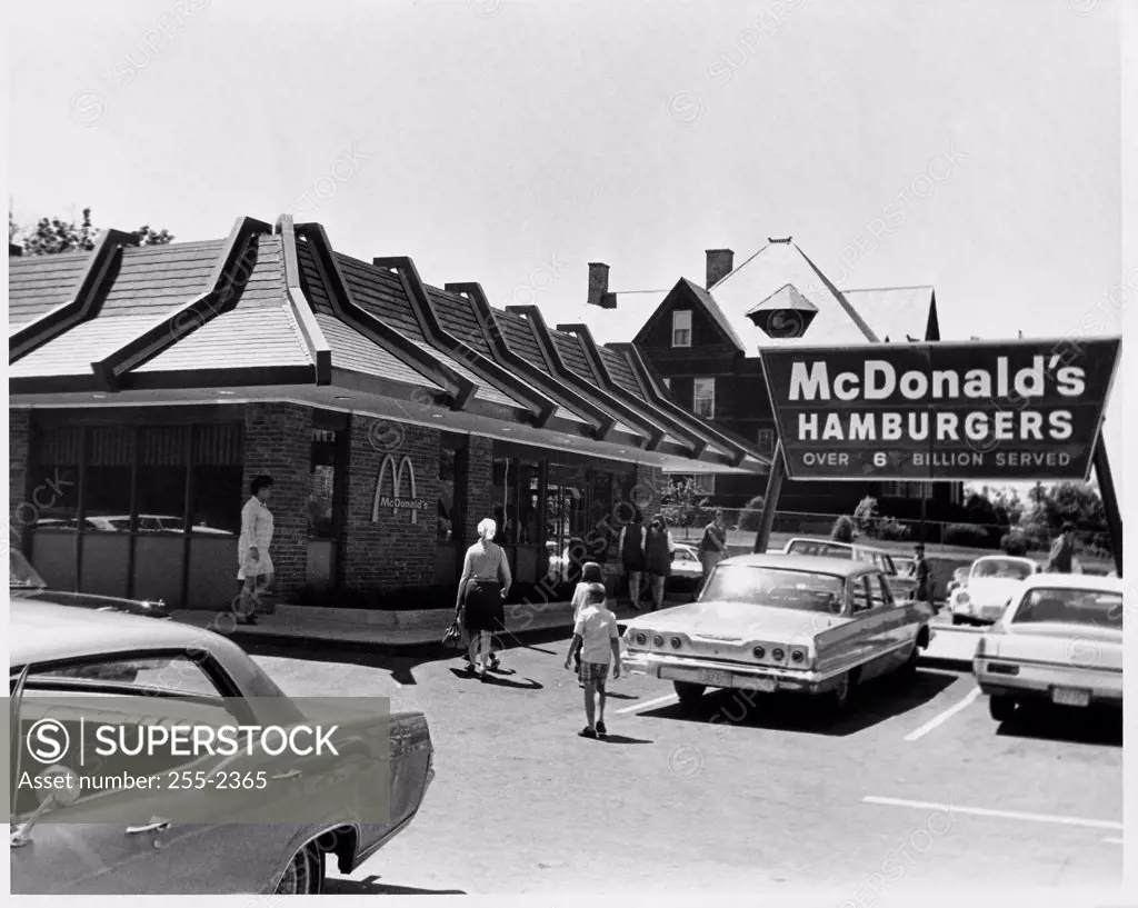 Cars parked in front of a restaurant, McDonald's restaurant