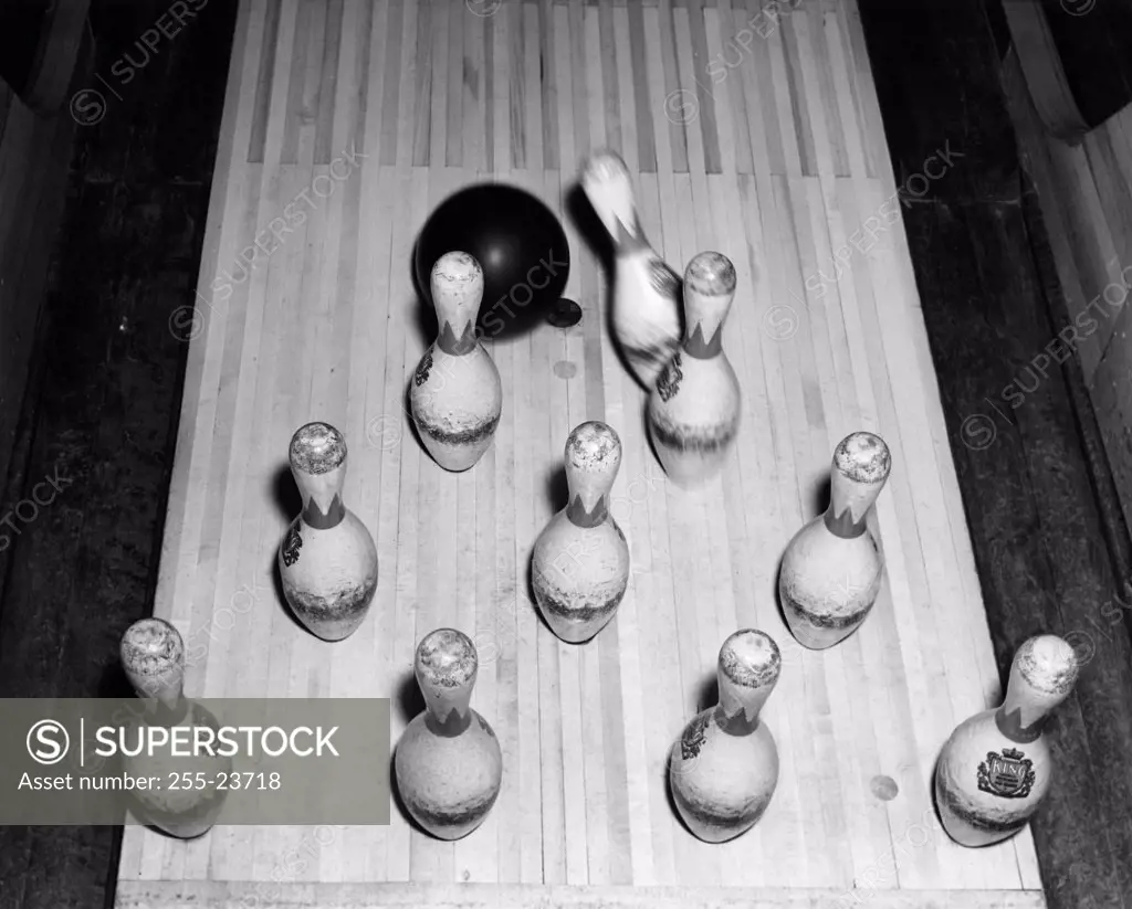 High angle view of a bowling ball knocking down bowling pins