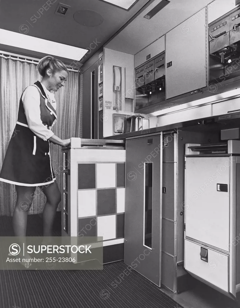 Side profile of a stewardess preparing a service cart