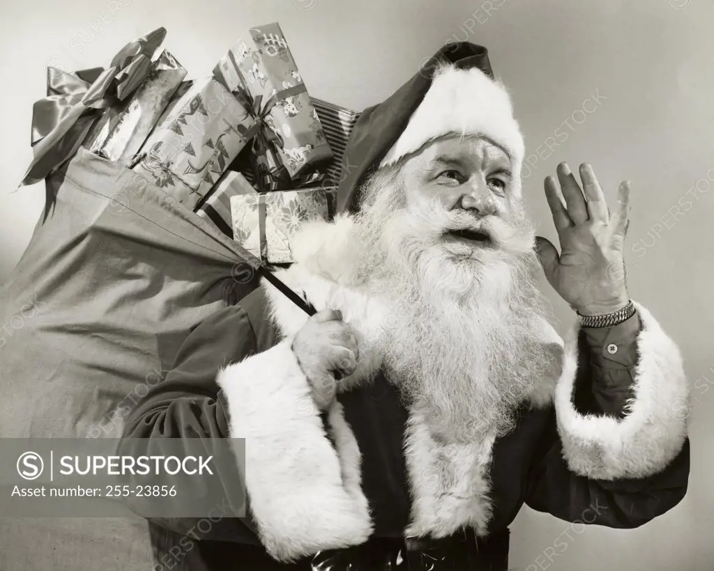 Close-up of Santa Claus carrying a sack of gifts on his back