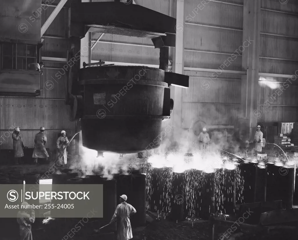 Molten steel being poured into molds in a steel factory