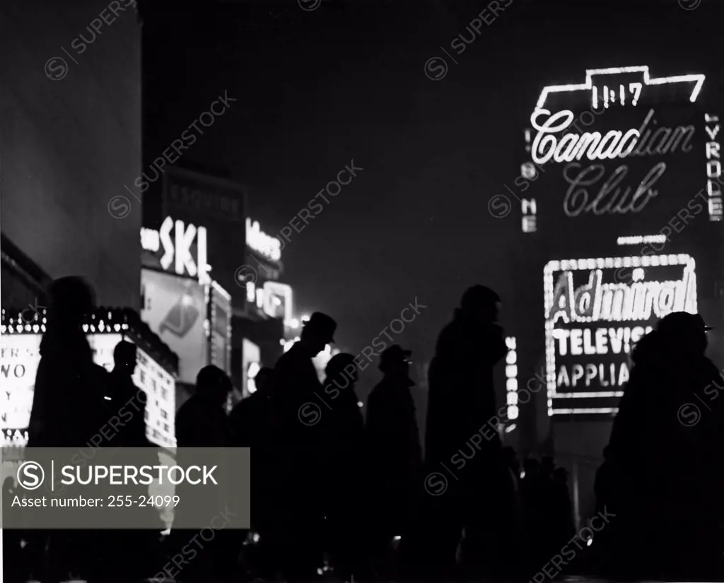 Group of people walking in front of a movie theater, Times Square, New York City, USA