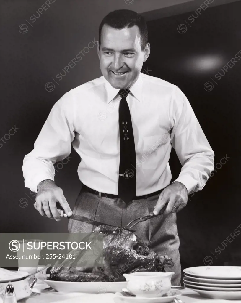 Mid adult man carving a turkey