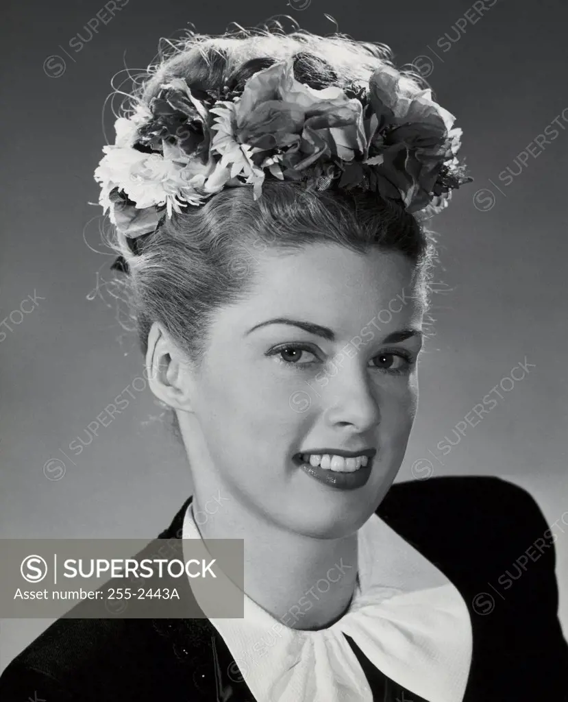 Vintage Photograph. Studio portrait of beautiful woman in jacket and earrings with flower headband