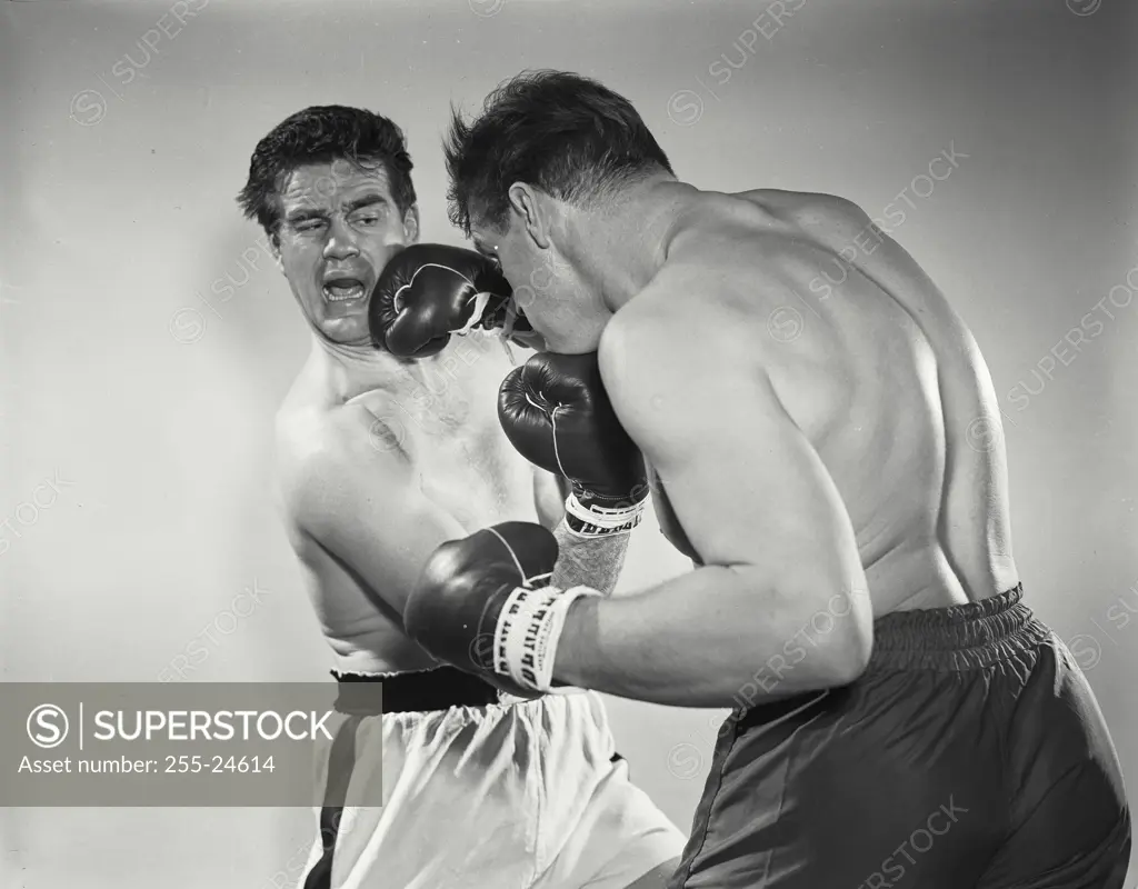 Vintage Photograph. Boxers wearing gloves in brawl. Frame 1