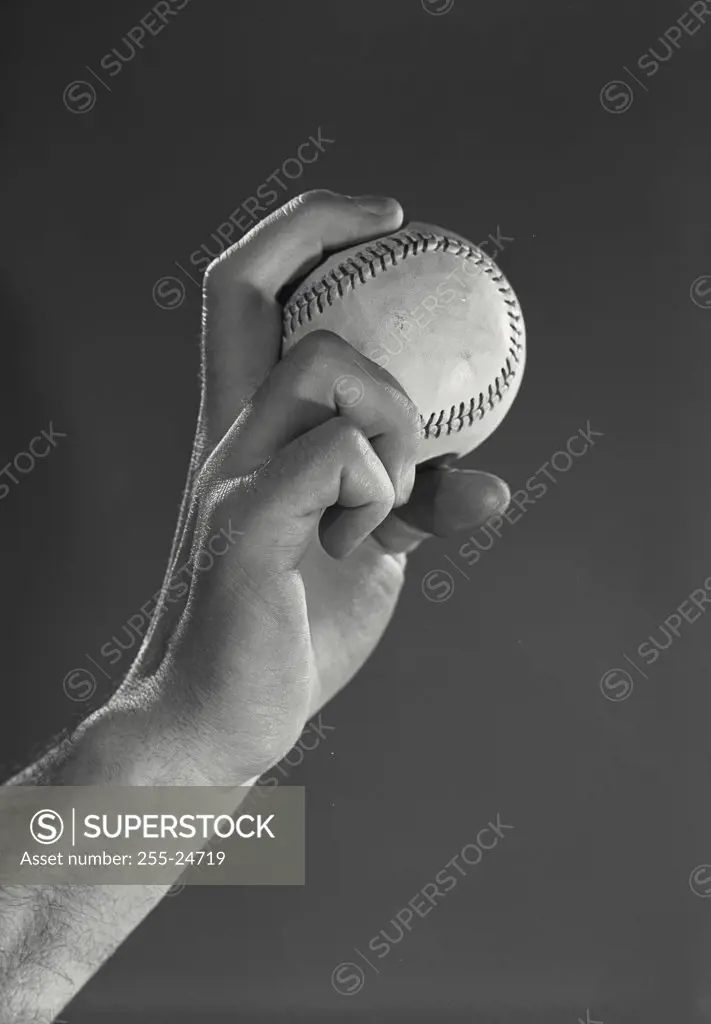 Vintage photograph. Hand gripping a baseball