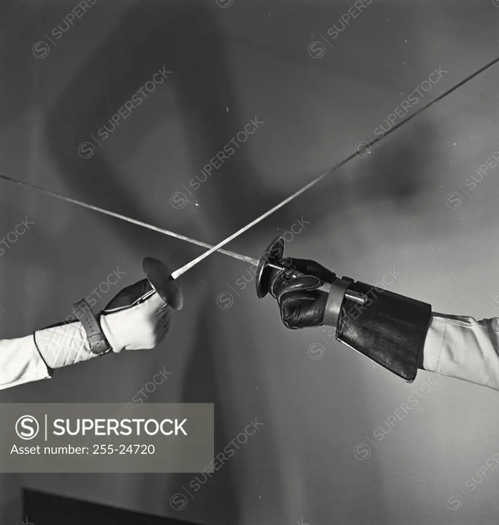 Vintage photograph. Hands of two fencers holding foils
