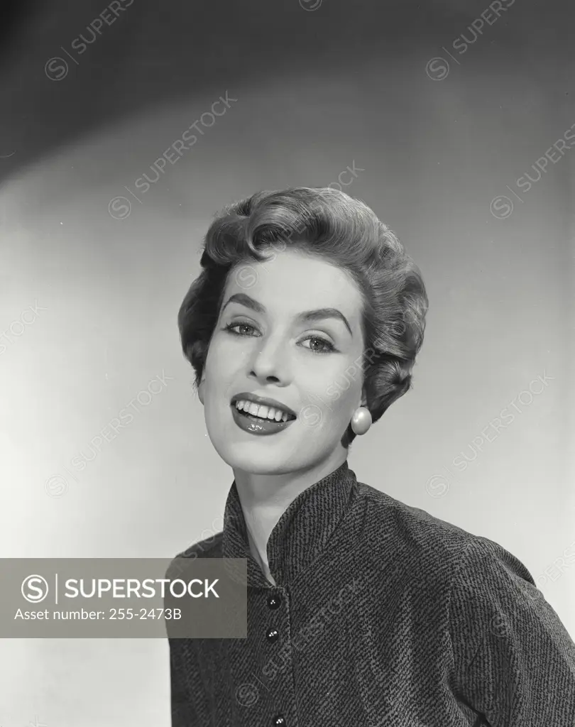 Vintage Photograph. Woman with short hairstyle wearing jacket with collar raised smiling looking at camera