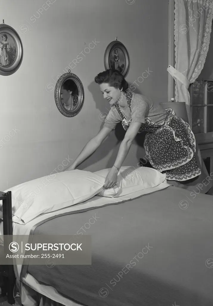Vintage Photograph. Woman making a bed. Frame 4