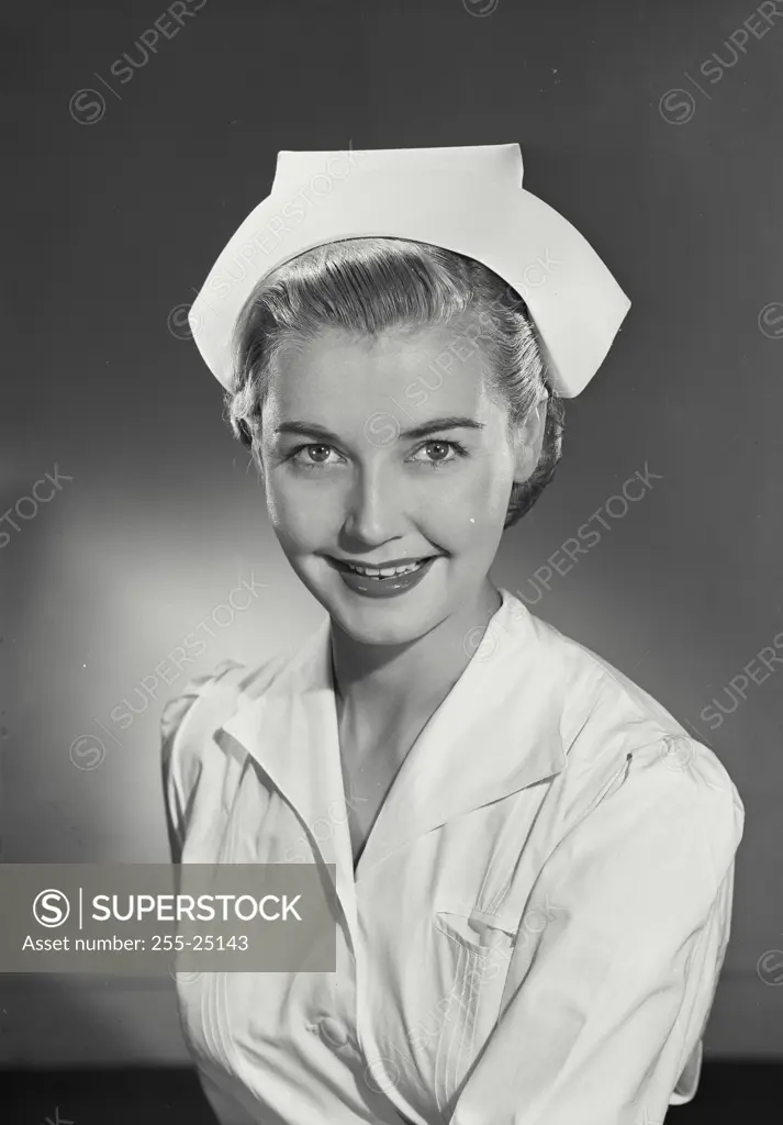 Vintage Photograph. Woman in nurses uniform smiling at camera