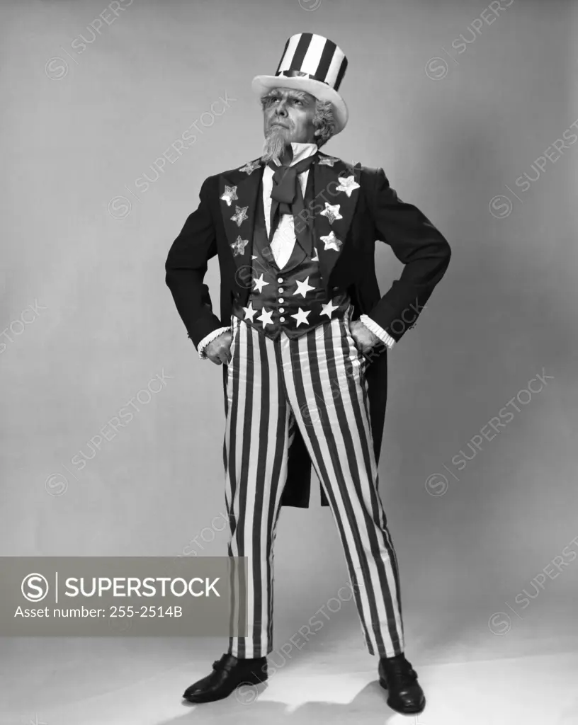 Senior man in Uncle Sam costume standing with arms akimbo