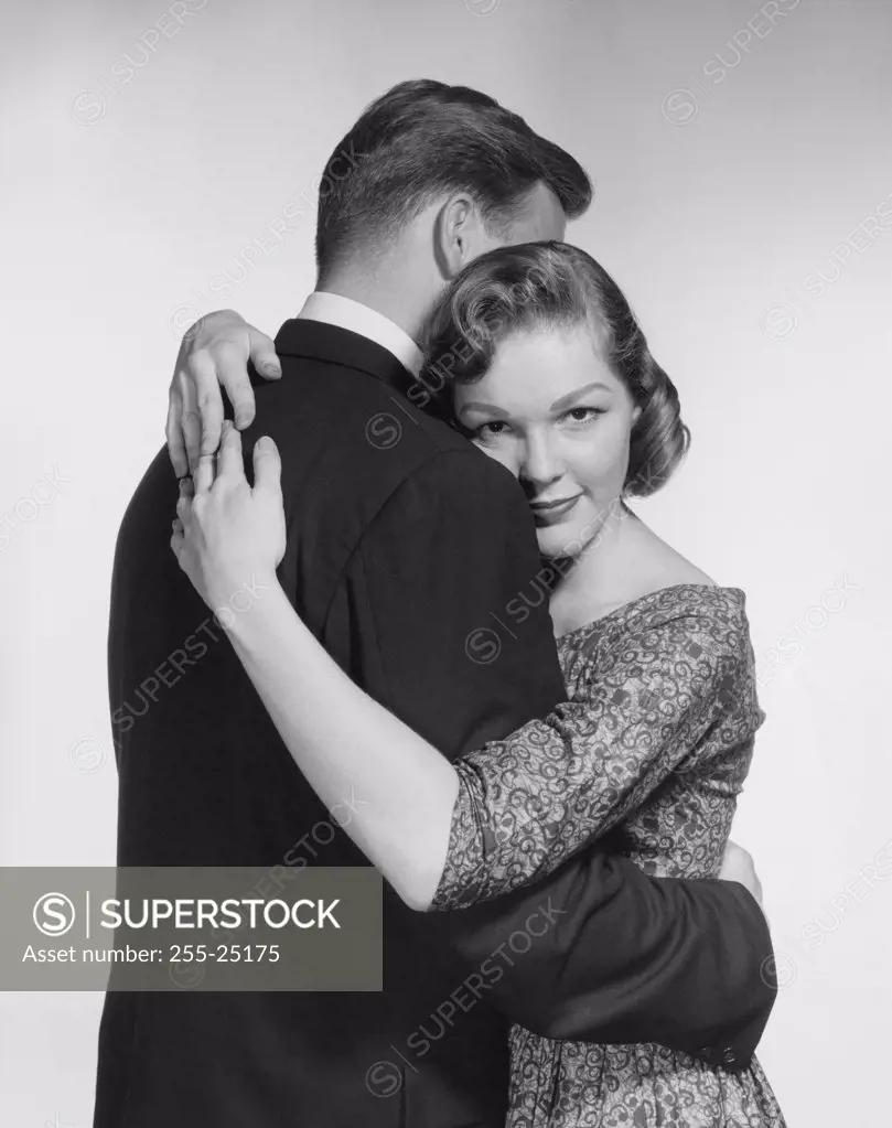 Side profile of a young couple embracing