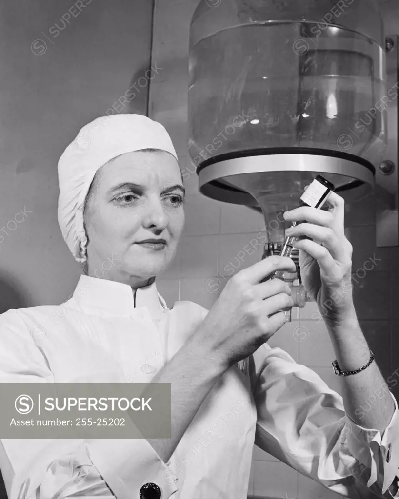 Close-up of a female nurse filling a syringe from a vial