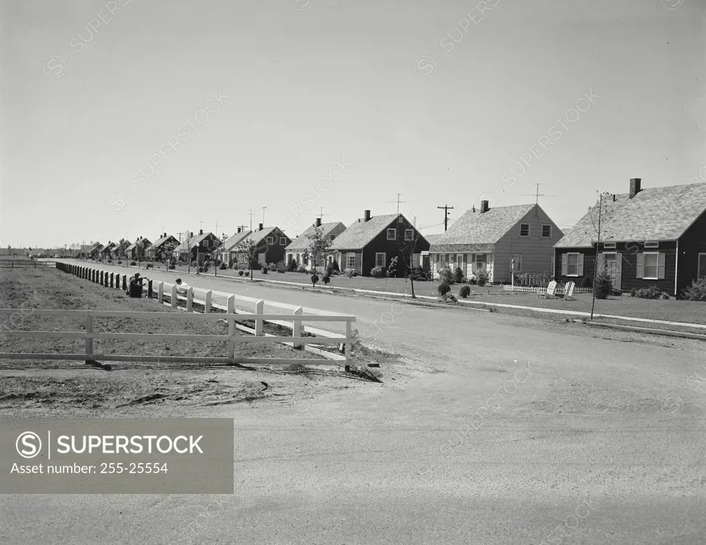Vintage photograph. Street scene in subdivision, houses, fence, Levittown, New York, USA