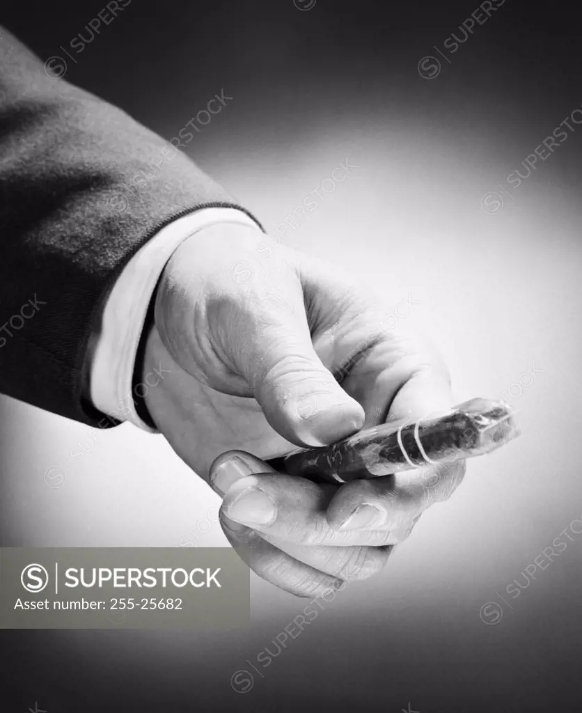 Man's hand holding cigar