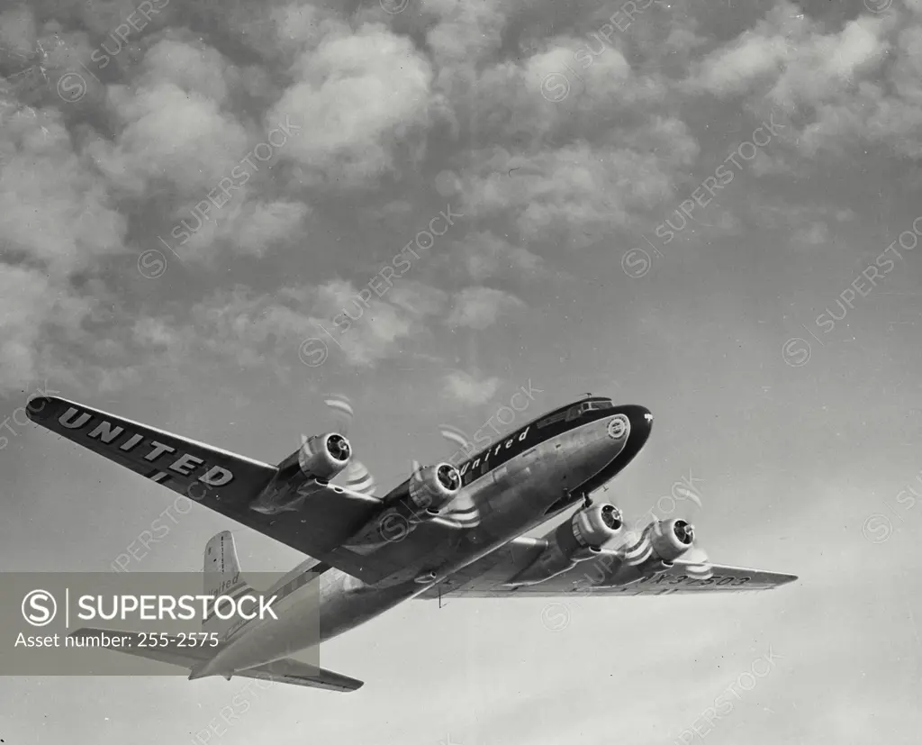 Vintage Photograph. Looking up at United Air Lines Mainliner airplane in flight