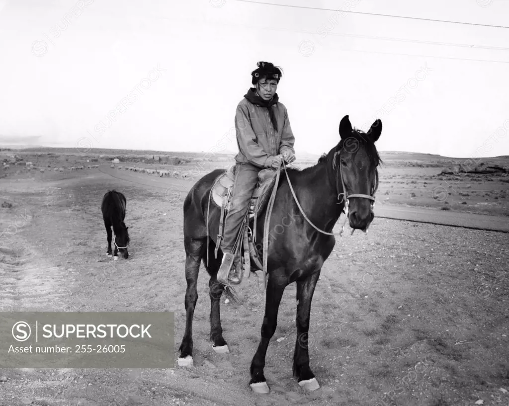 Navajo woman riding a horse, Arizona, USA
