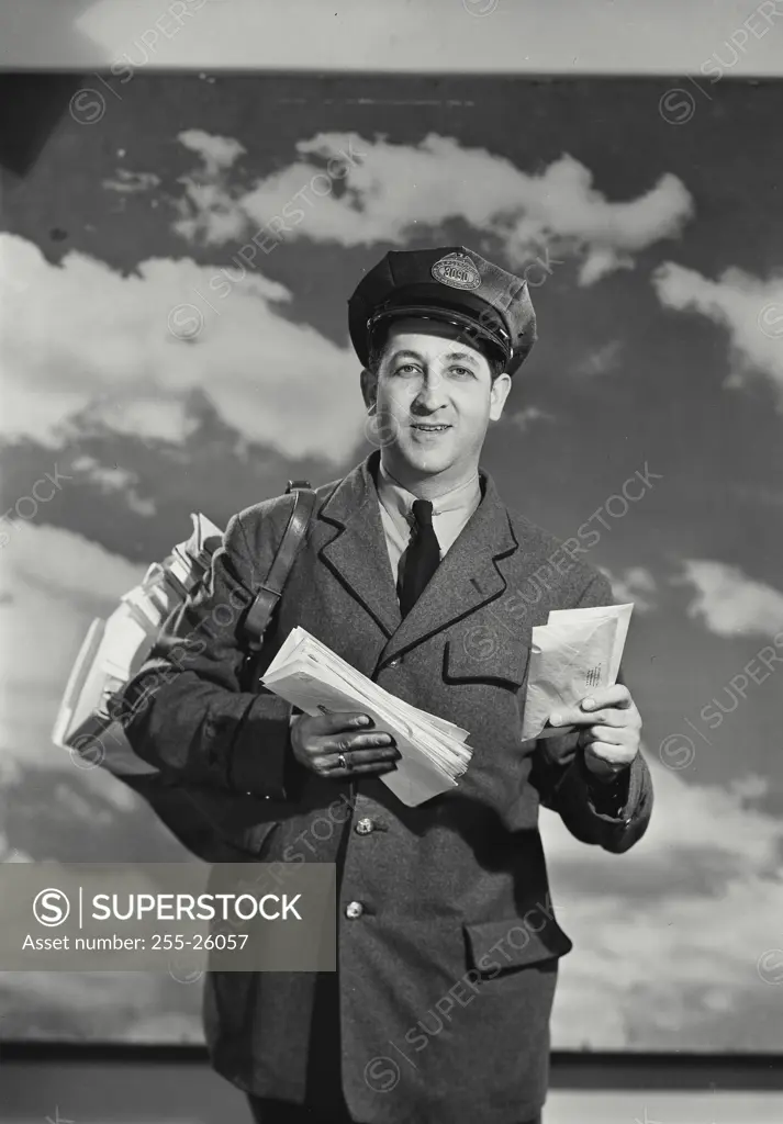 Vintage Photograph. Mailman holding bag of mail and a letter. Frame 1