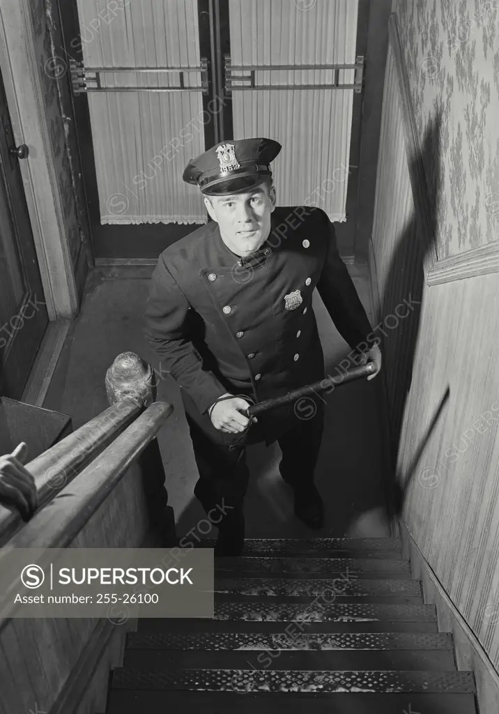 Vintage Photograph. Police officer lurking in stairway. Frame 2